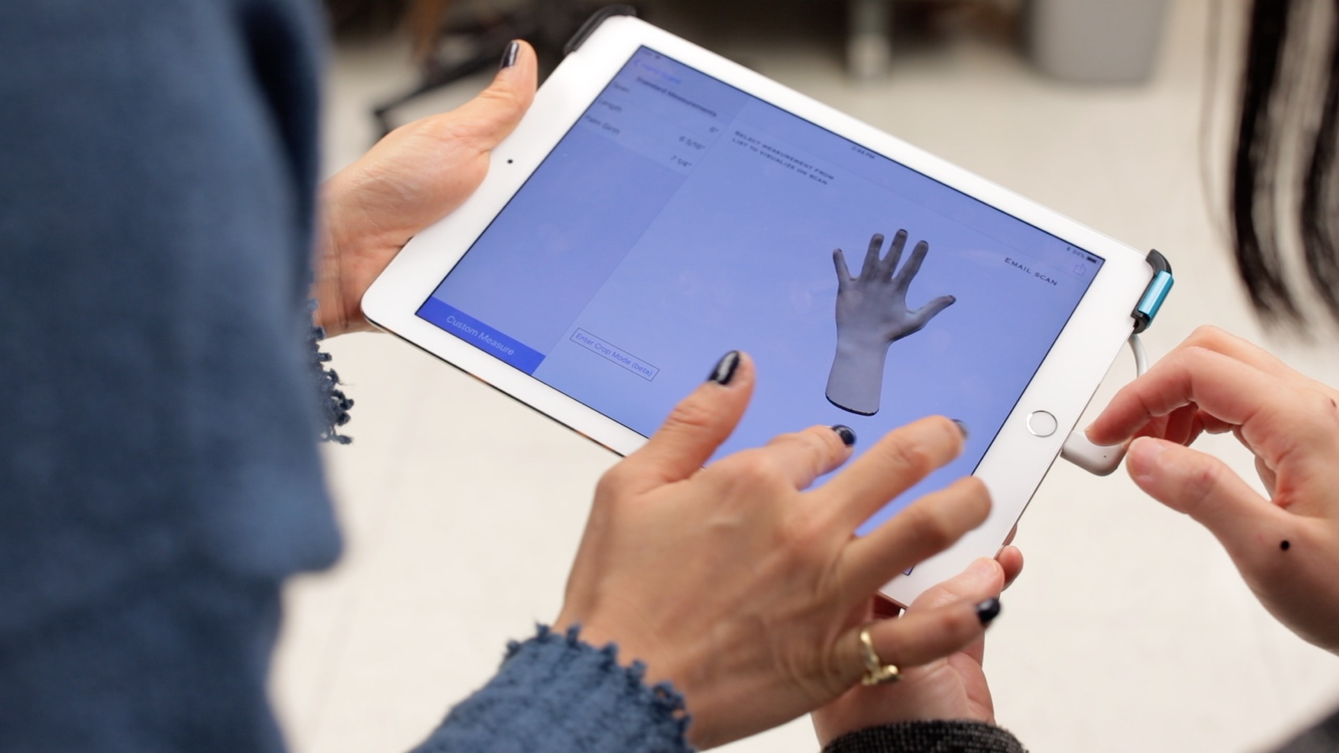 Close up of hands holding an iPad displaying research